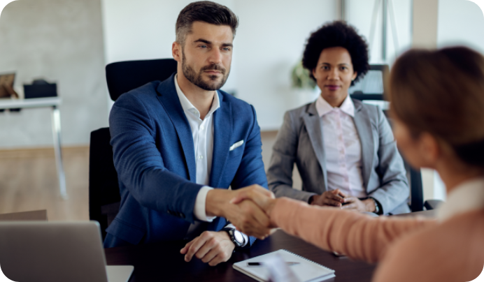 Businessman shaking hands representing employment-based visa services