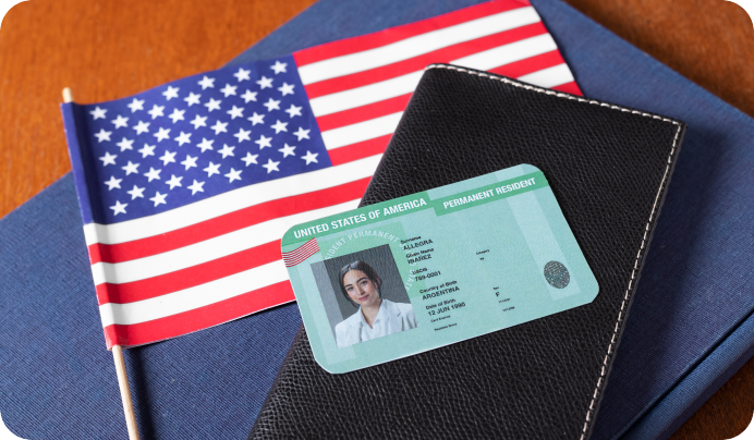 U.S. green card and passport with American flag representing employment-based green cards