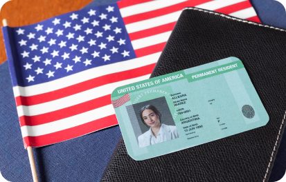 U.S. green card and passport with American flag representing employment-based green cards